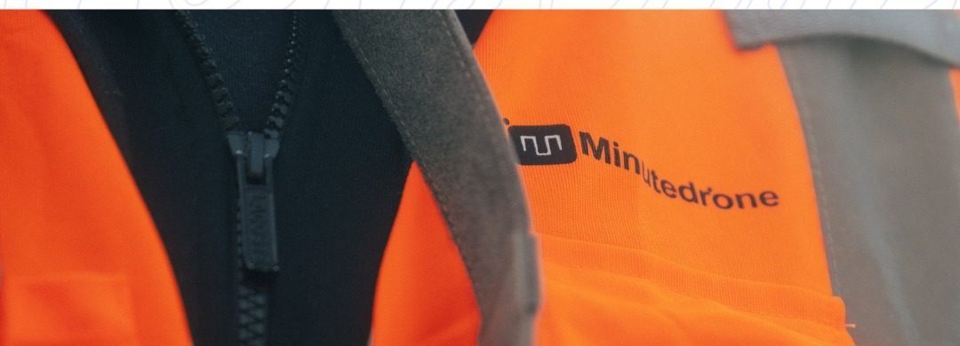 Gilet orange floqué du logo Minutedrone